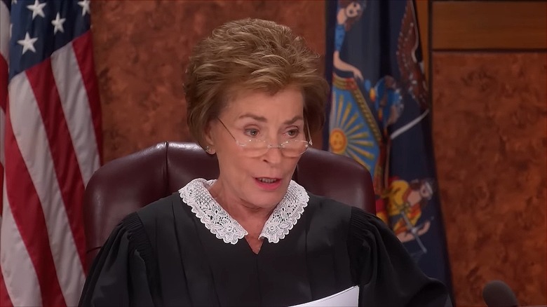 Judge Judy peering over her glasses from behind the bench