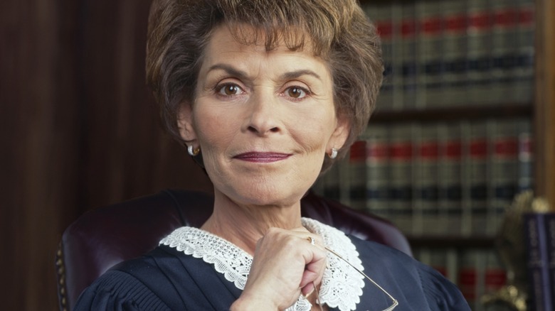 Judge Judy in the 1990s holding her glasses