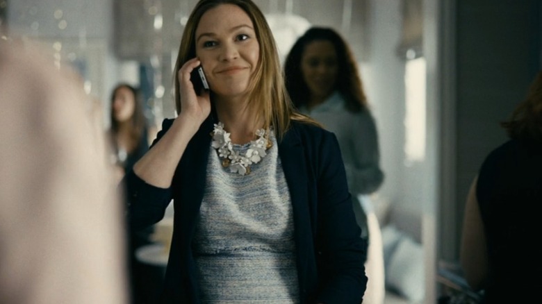 Julia Stiles as Elizabeth on the phone at a party in Hustlers