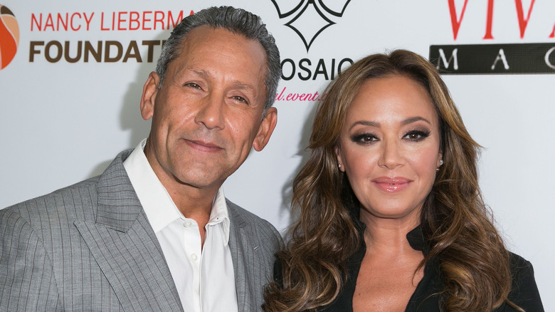 Angelo Pagan and Leah Remini posing at a VIVA GLAM event