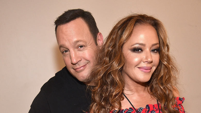 Kevin James and Leah Remini posing together at a Billy Joel concert