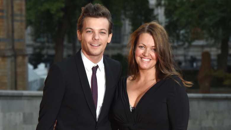 Louis Tomlinson and his mother Johannah Deakin smiling