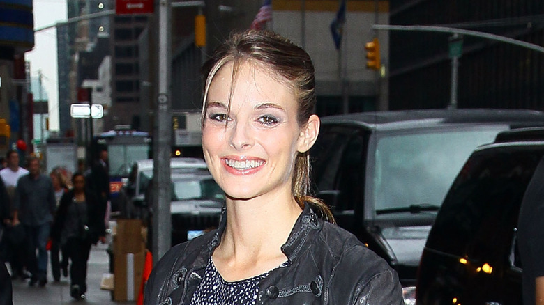 Lisa Kelly smiling on a city sidewalk