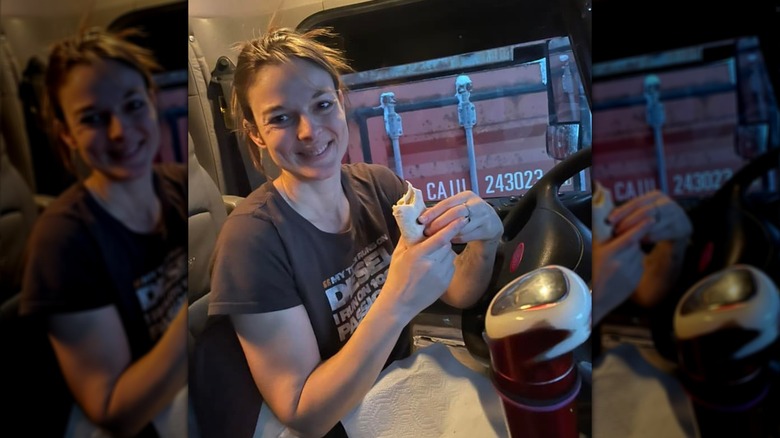 Lisa Kelly eats inside the cab of her truck.