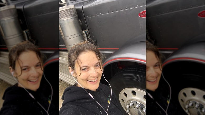 Lisa Kelly takes a selfie with a truck.