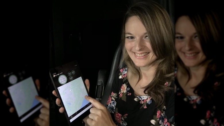 Lisa poses with a map on an iPad.