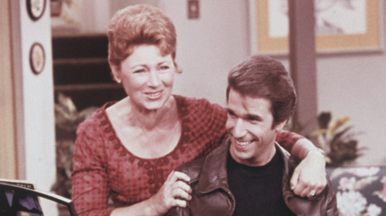 Marion Ross and Henry Winkler smiling in happy Days scene