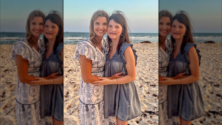 Missy Robertson and Mia Robertson posing on a beach