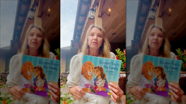 Missy Robertson holding a copy of her book