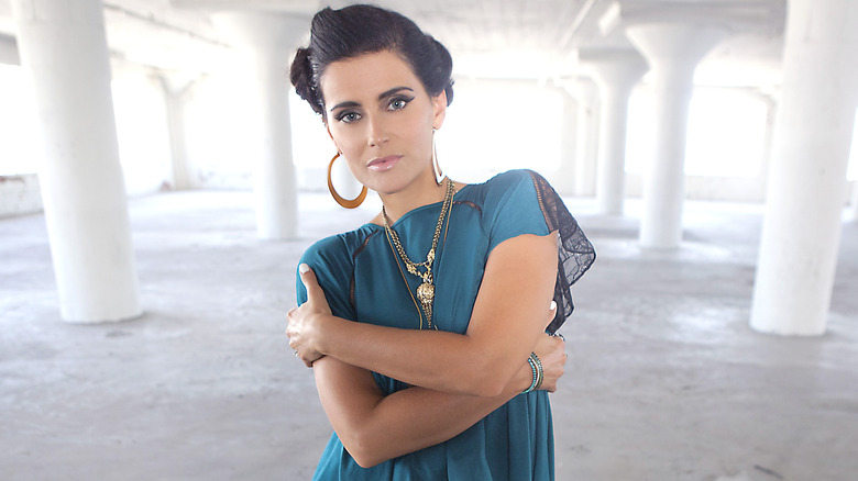 Nelly Furtado posing and smiling 