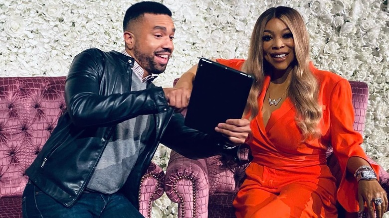 Norman Baker posing with Wendy Williams wax figure