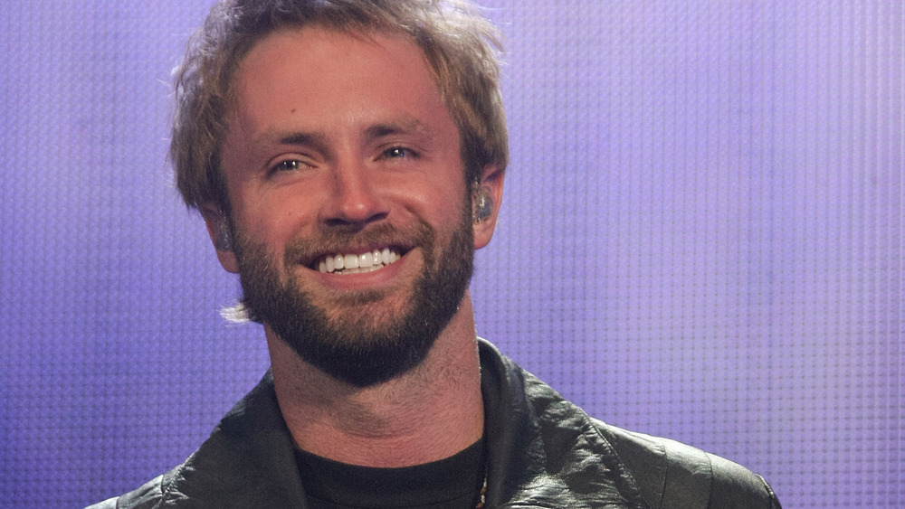 Paul McDonald smiling on stage 