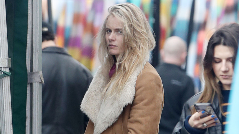 Cressida Bonas out at London market and looking intently into paparazzi camera