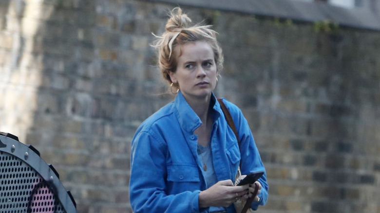 Cressida Bonas texting as she walks through London