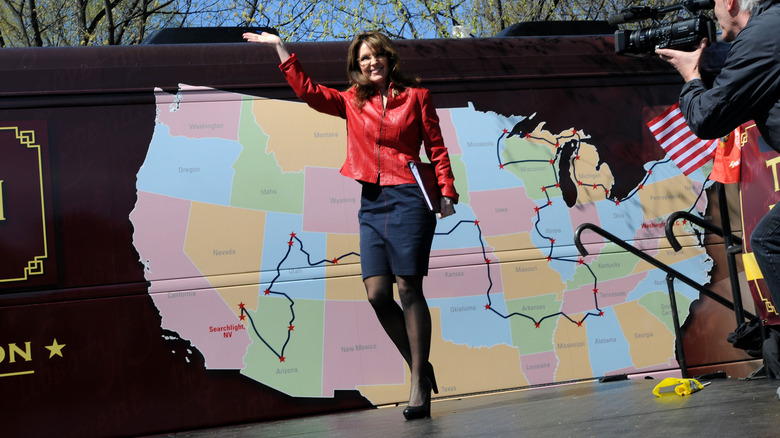 Sarah Palin at a 2010 Tea Party rally, waving on stage