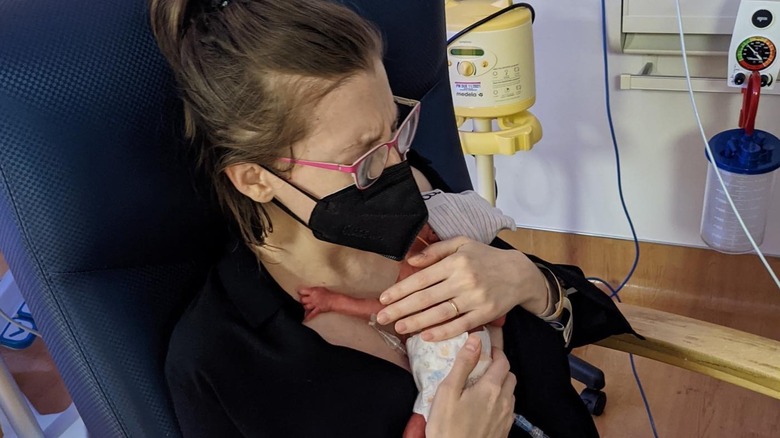 Eden Sher holding one of her premature twins in the hospital