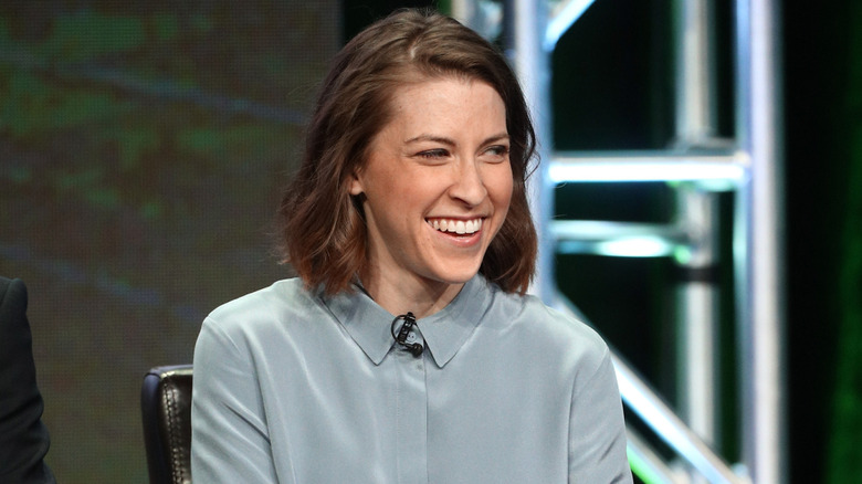 Eden Sher smiling on stage at the Summer Television Critics Association Press Tour