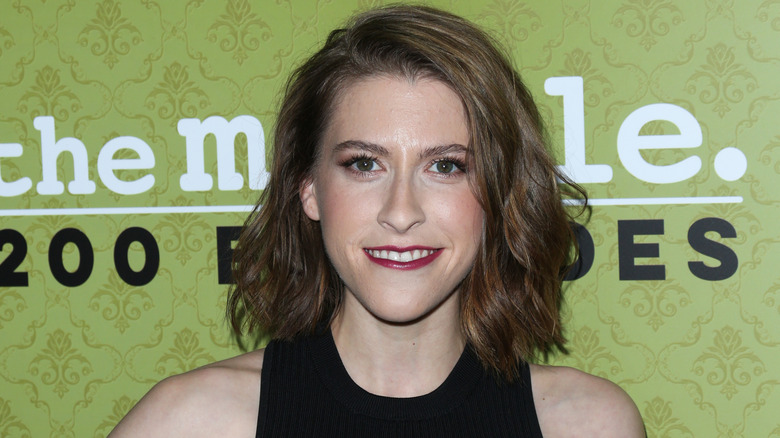 Eden Sher posing on step-and-repeat