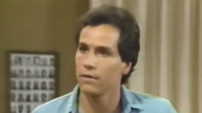 Actor Paul Regina looking off camera with a serious expression on the set of "Brothers."