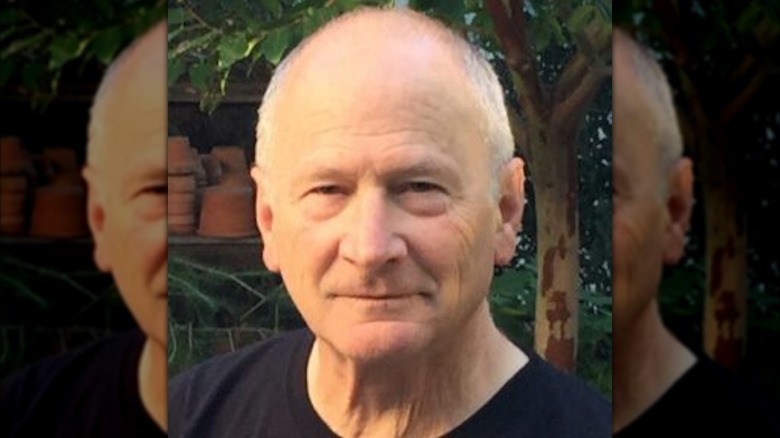 Actor Philip Charles MacKenzie half-smiling outside.