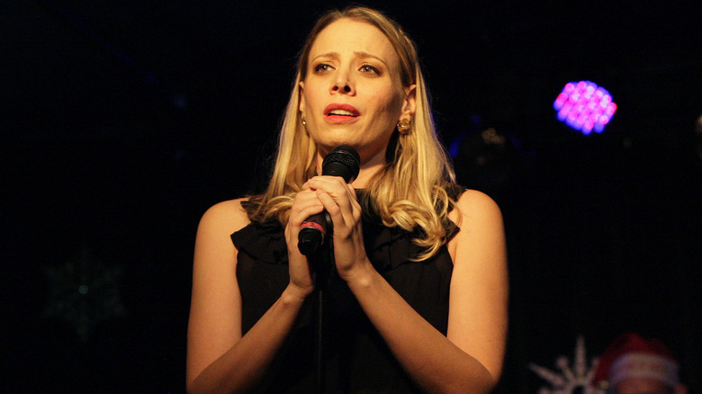 Stacey Oristano holding a microphone
