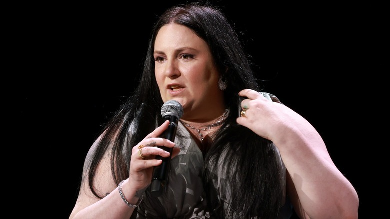 Lena Dunham speaking into a microphone in 2025