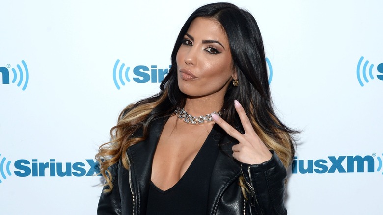 Natalie Guercio holding up a peace sign in 2014