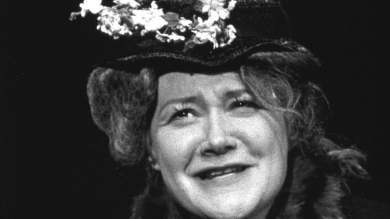 Dody Goodman wearing a flowered hat
