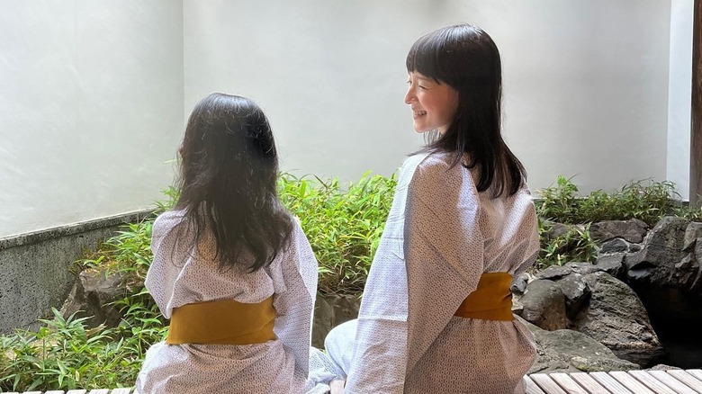 Marie Kondo smiling at her daughter, whose back is turned to the camera