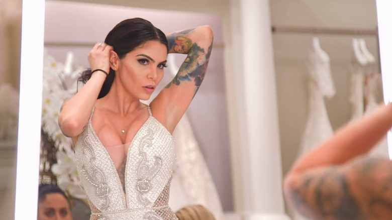 Camila Lincowski looking at her wedding dress in a mirror on "Say Yes to the Dress"