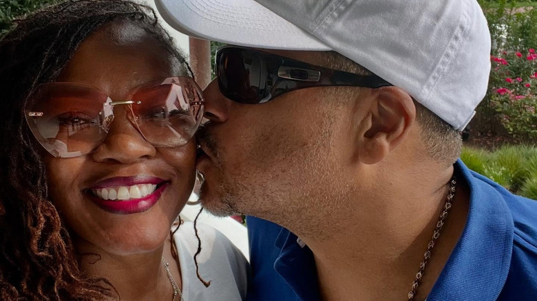 Pat Neely wearing a cap and kissing his wife Tamika