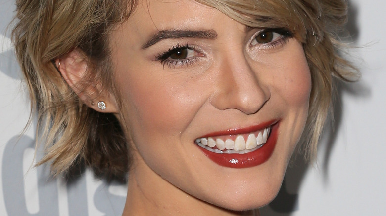 Linsey Godfrey smiling on the red carpet