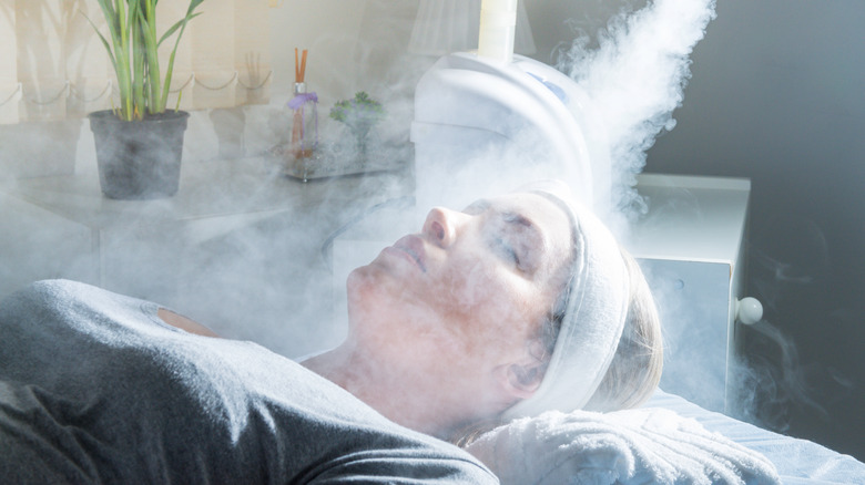 woman receiving facial steam