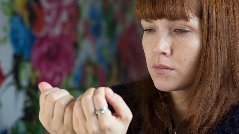 Woman looking at nails