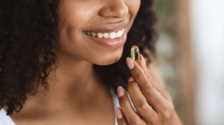 woman taking omega 3 supplement