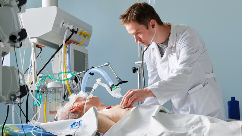 Doctor attending an intubated patient