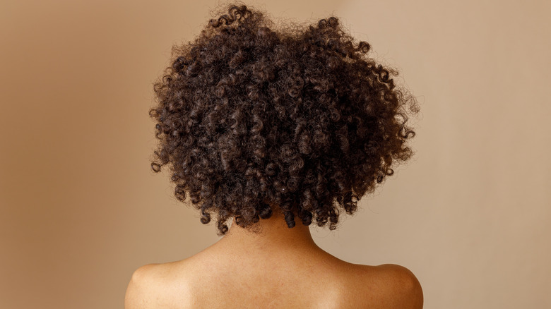 Woman showing naturally curly hair