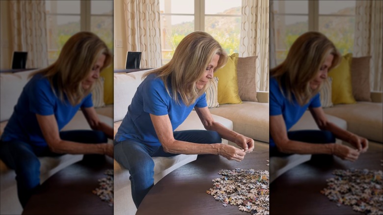 Vanna White doing a puzzle at home