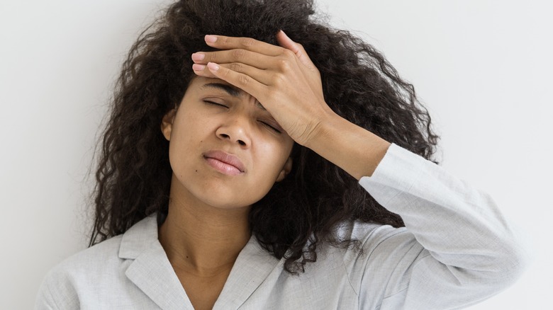 Woman holding her head in pain