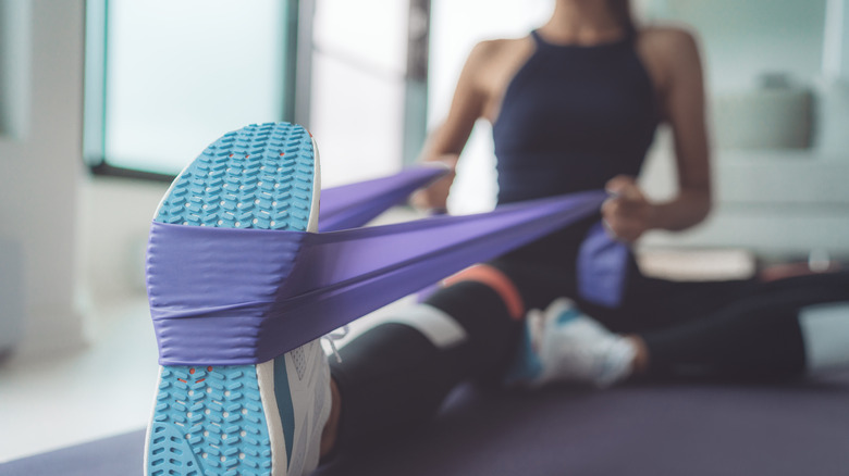 Woman uses resistance band