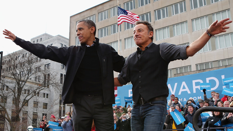 Barack Obama and Bruce Springsteen waving