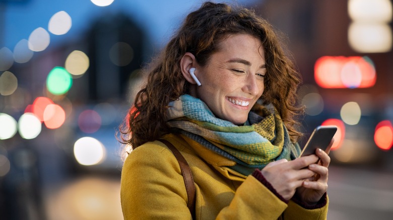 smiling woman sending text