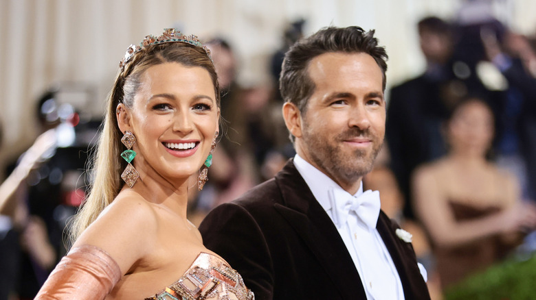 Blake Lively and Ryan Reynolds smiling on the Met Gala carpet