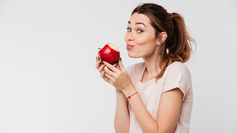 Woman biting into an apple