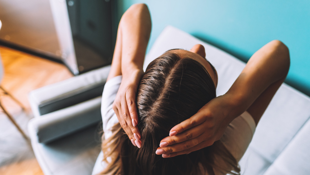 Woman massaging her scalp