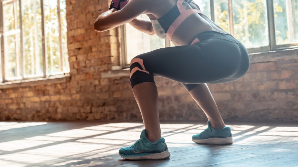 Woman doing squats as calisthenics
