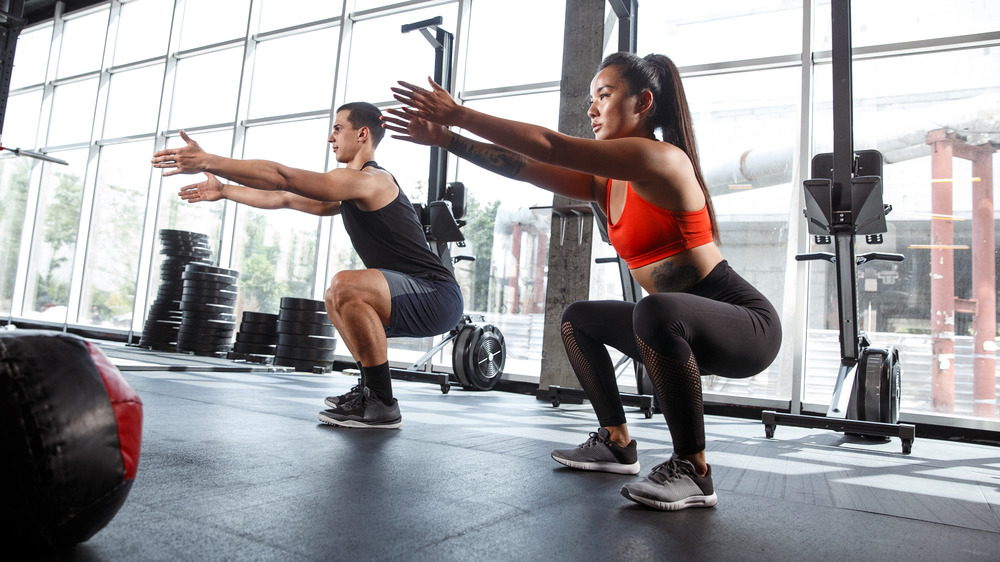 Man and woman workout squats