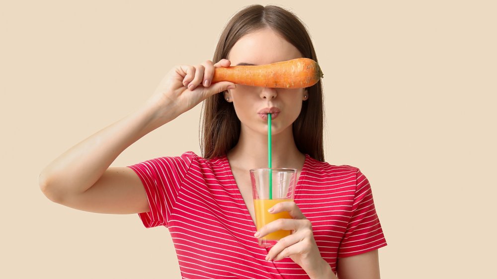 Woman drinking carrot juice