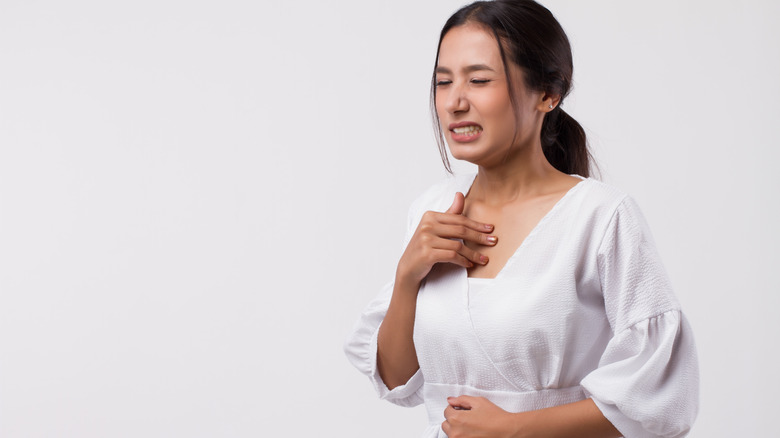 a woman experiencing heartburn