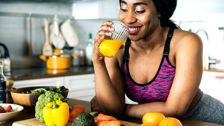 a woman drinking orange juice